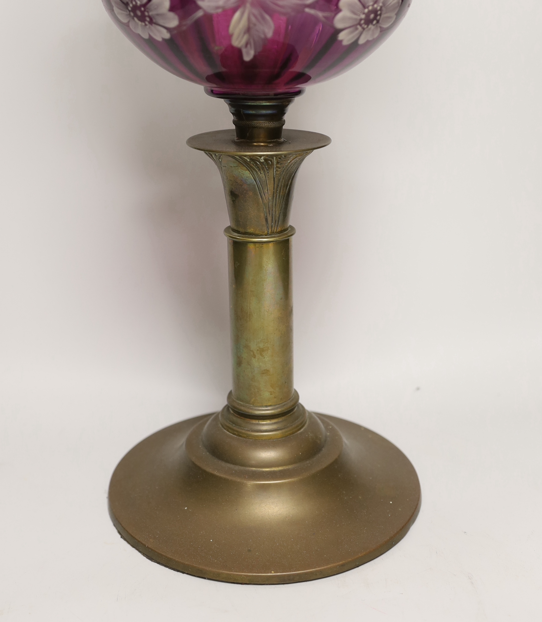 A Victorian oil lamp with an amethyst floral enamelled glass bowl and clear etched shade, 65cm high
